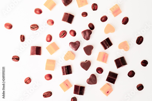 Small chocolate candies in the form of hearts, and coffee beans
