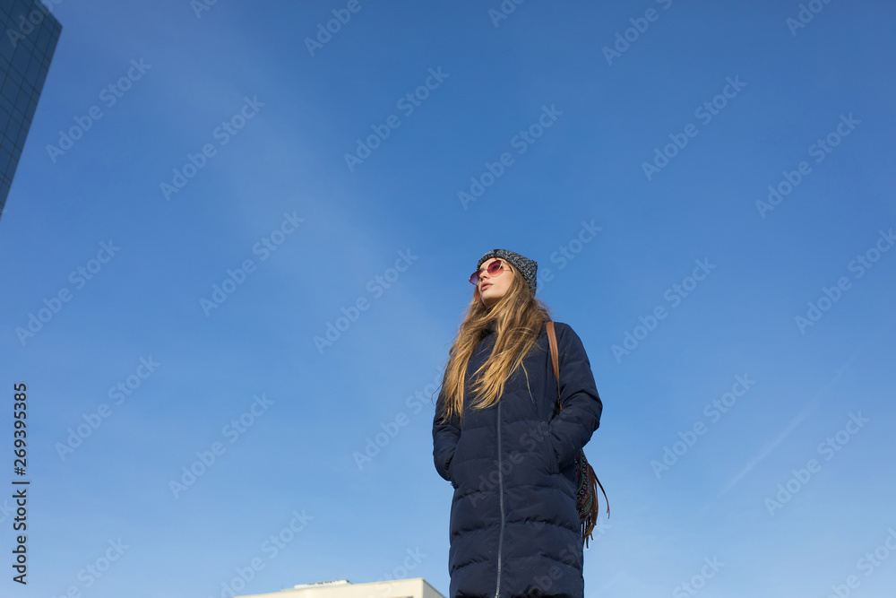 young woman on background of blue sky young woman on background of blue sky