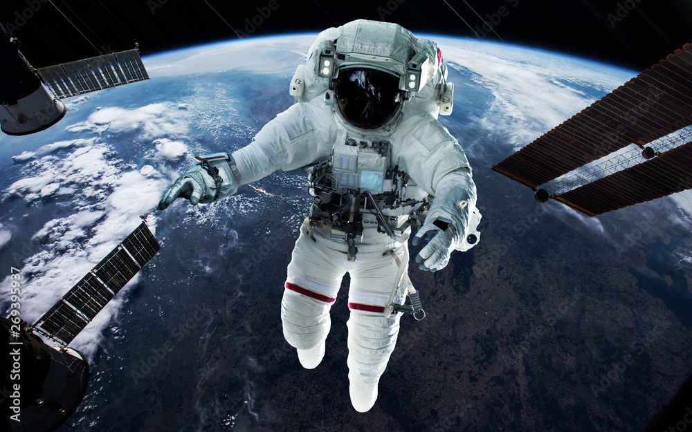 Naklejka premium Astronaut at the Earth planet orbit. Awesome science fiction render. Elements of this image furnished by NASA