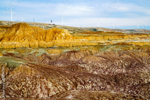 Rainbow Beach Wind Power in Burqin County, Xinjiang, China. Wind power white windmill in Xinjiang Yadan landform photo