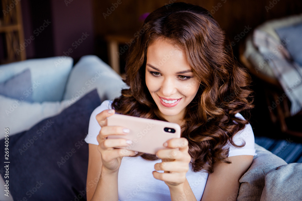 Close-up portrait of her she nice attractive lovely cute charming lovable sweet shine cheerful cheery wavy-haired girl browsing chatting at industrial loft wooden brick style interior room