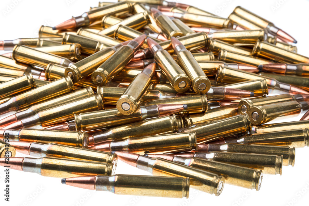 cartridges for 308 caliber rifle on a white background. a bunch of ammo. cartridges scattered on a light background cartridges for 308 caliber rifle on a white background. a bunch of ammo. cartridges scattered on a light background