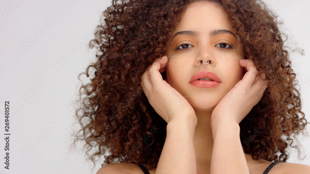 Fototapeta premium mixed race model with freackless put her head on hands and watching to the camera