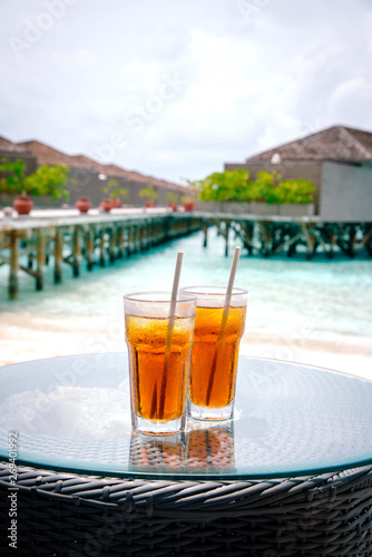 Iced tea against tropical Overwater Bungalow Resort, Maldives.