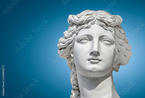 Portrait of a statue of young beautiful sensual Renaissance Era women in Vienna at smooth gradient blue background, Austria
