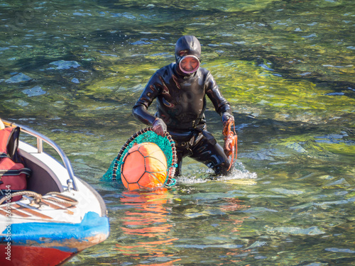 Jeju Island, South Korea - October 15, 2018: Haenyeo Women Diver Show to collect seaweed, shellfish and other seafood at Seongsan Ilchulbong.