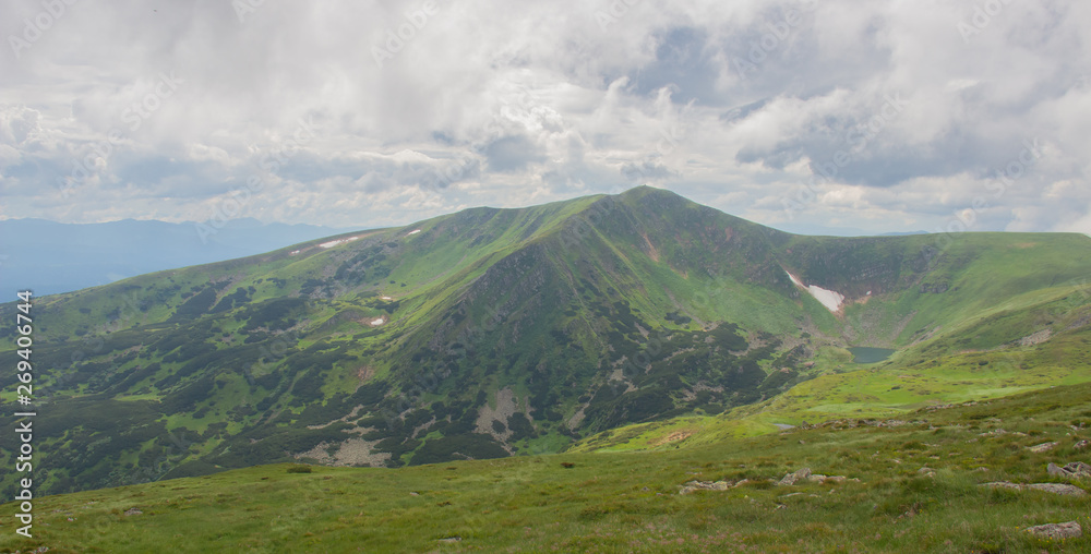 Fototapeta premium Hiking with a tent through Petros to Hoverla, Lake Nesamovite, Mount Pop Ivan Observatory.