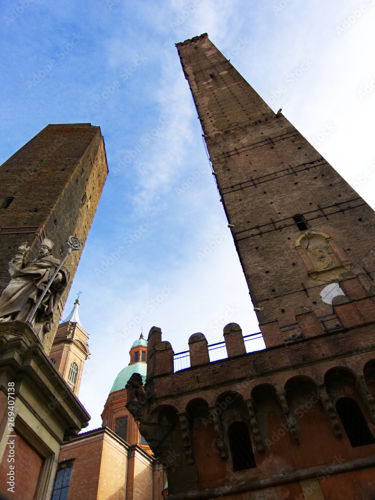 Main medieval towers in Bologna: Asinelli and Garisenda, statue of Saint Petronius, Italy