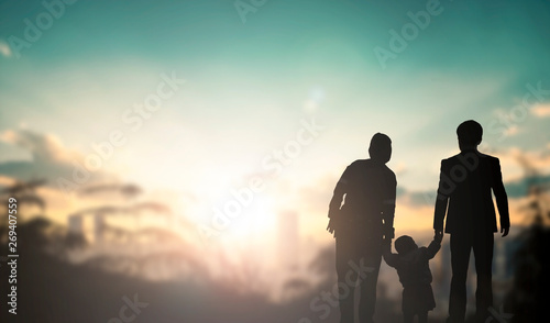 Foto Family concept: family at sunset background