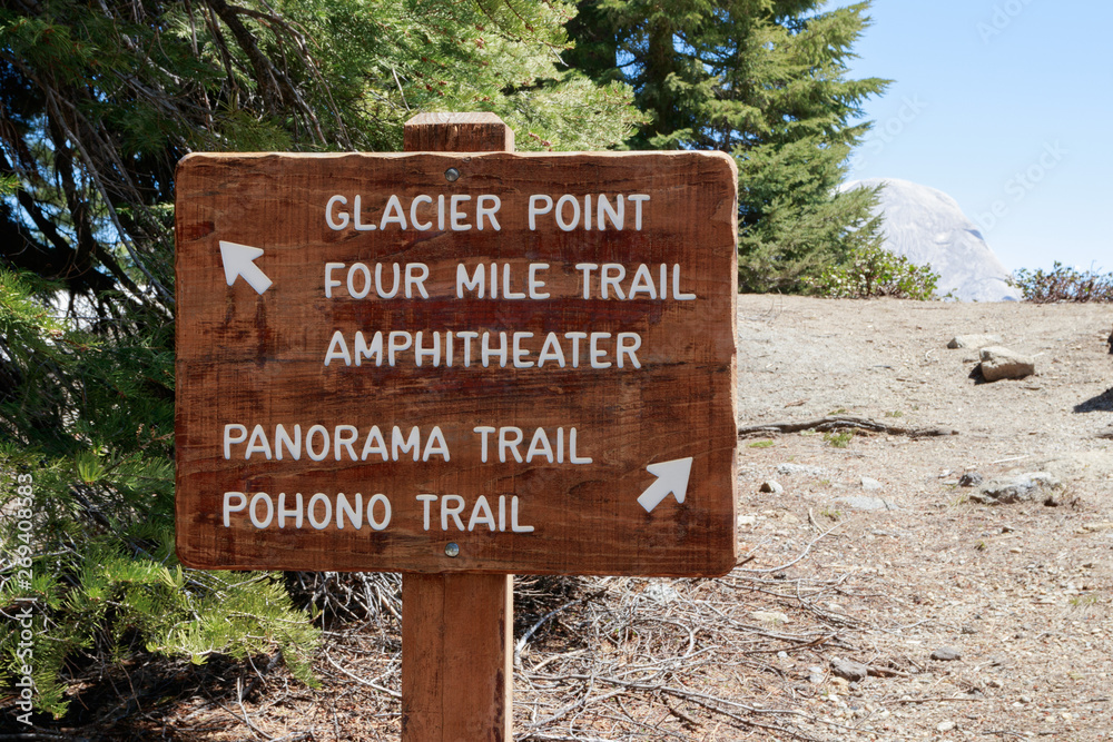 Glacier Point , Four Mile Trail direction in Yosemite National Park . Panorama trail sign on the wood plate