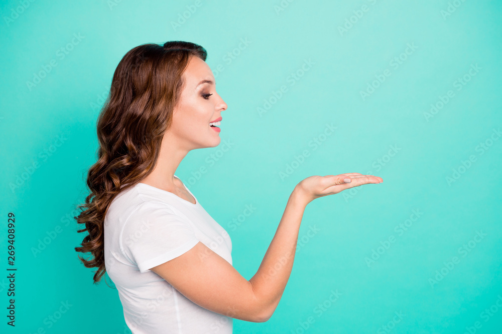 Profile side view portrait of her she nice-looking attractive lovely sweet perfect feminine cheerful cheery wavy-haired lady holding invisible copy space isolated on bright vivid shine blue background Profile side view portrait of her she nice-looking attractive lovely sweet perfect feminine cheerful cheery wavy-haired lady holding invisible copy space isolated on bright vivid shine blue background