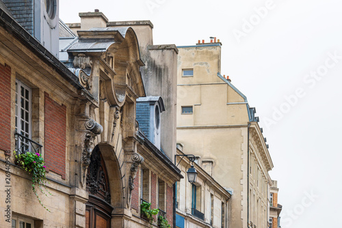 Antique building view in Paris city, France.