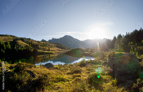 sunrise in the austrian alps on a mountain lake