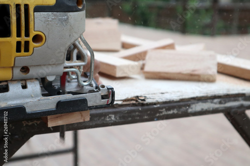 carpenter cutting wood with saw