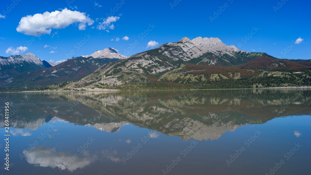 Reflection of mountains in Jasper Lake, Yellowhead Highway, Jasper National Park, Jasper, Alberta, Canada