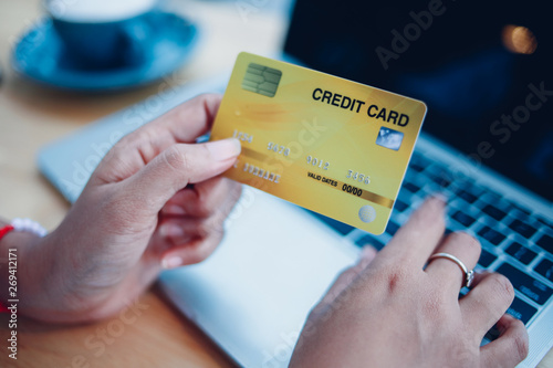 woman hard using credit card with laptop comouter photo