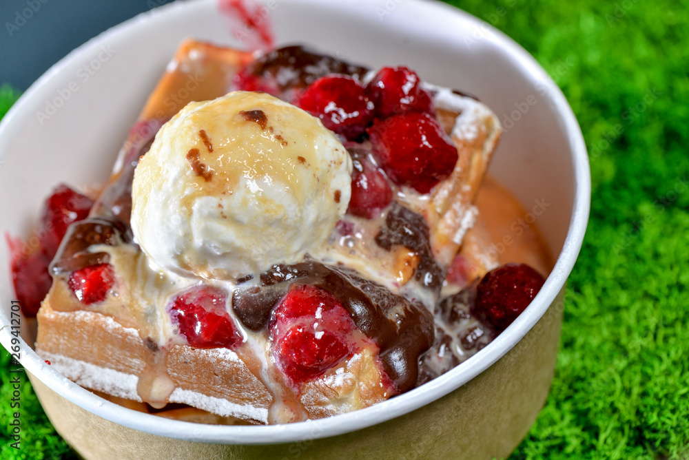 Dessert Belgian waffles with frozen chocolate doused with caramel and berries Dessert Belgian waffles with frozen chocolate doused with caramel and berries