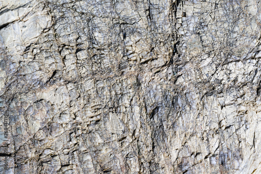 Close up macro view of cracked stone surface gray color. Detailed nature background or pattern texture taken in natural environment. Weathered many years, inimitable, unique effect to textured design Close up macro view of cracked stone surface gray color. Detailed nature background or pattern texture taken in natural environment. Weathered many years, inimitable, unique effect to textured design