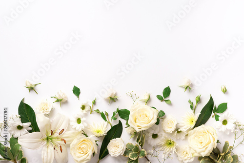 Spring composition of rose flowers on white background with copy space. Creative layout. Flat lay. Top view. Summer minimal concept. photo