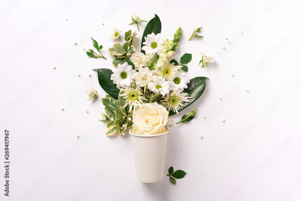 Creative layout made of paper cup with white flowers. Flat lay, top view. Banner with copy space. Valentines day, Woman day concept. Spring or summer banner with copy space