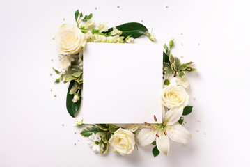 Summer composition of white flowers on light paper background with copy space. Creative layout. Flat lay. Top view. Spring minimal concept.