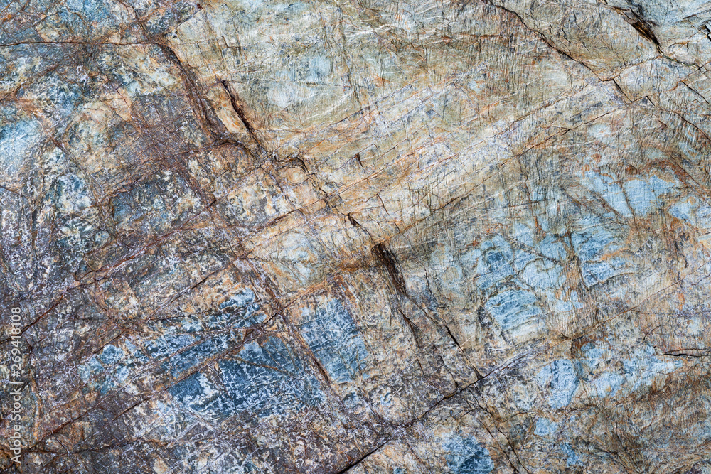 Cracked stone surface gray, brown, blue color. Nature background pattern texture