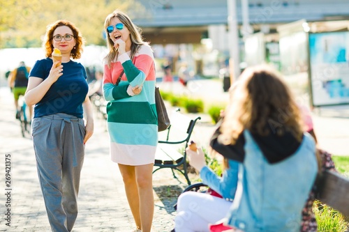 Two attractive women in the city chatting together photo