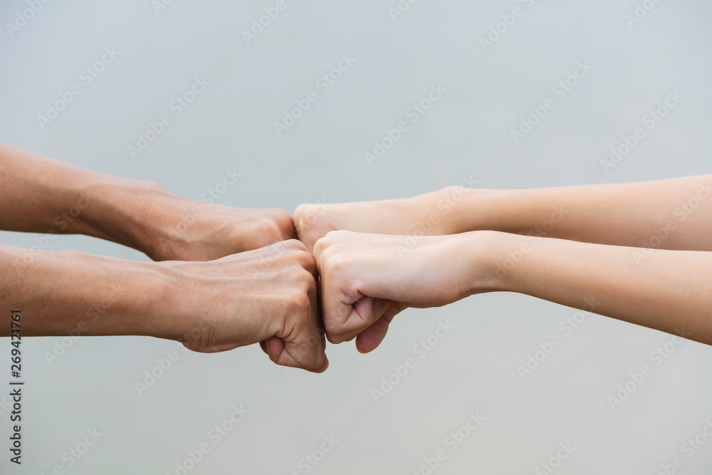 Friend fist bump together at outdoor. Fist bump between colleagues. Friendship and teamwork concept. Friend fist bump together at outdoor. Fist bump between colleagues. Friendship and teamwork concept.