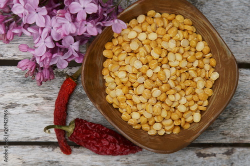 A bowl of uncooked Chana daal or yellow split peas. photo