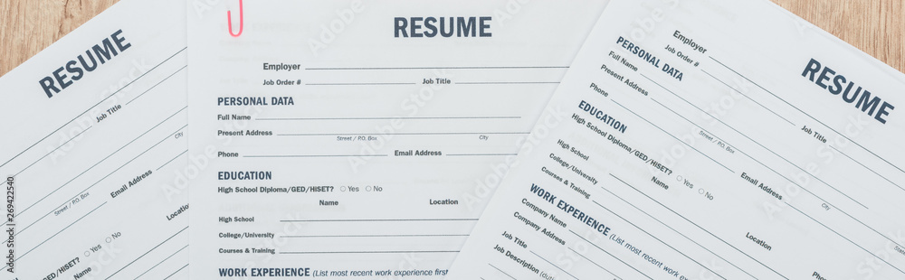 panoramic shot of print resume templates on wooden surface panoramic shot of print resume templates on wooden surface