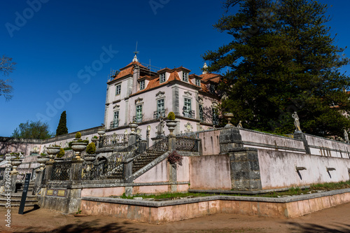 Oeiras - Lisbon, Portugal - March 10, 2019 - Perspective of the Marquis of Pombal Palace from the garden, sighting the staircases and decorative statues
