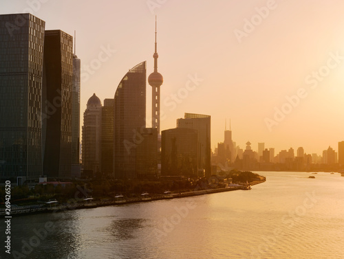 Shanghai skyline and Huangpu river in a beautiful dusk scene with sunset glow 