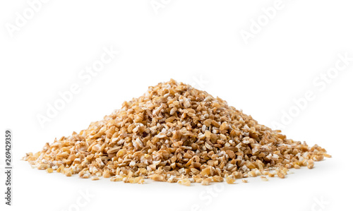 Heap of dry wheat groats on a white background, isolated.