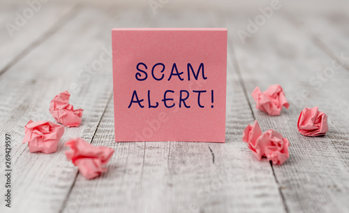 Handwriting text writing Scam Alert. Conceptual photo fraudulently obtain money from victim by persuading him Thick set of plain note paper with scraps on the wooden textured table