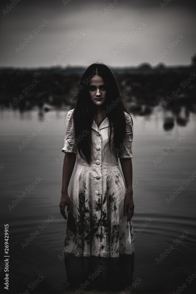 Portrait of asian woman make up ghost face at the swamp,Horror