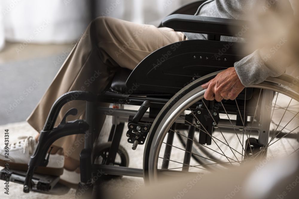 Obraz premium partial view of disabled senior woman on wheelchair
