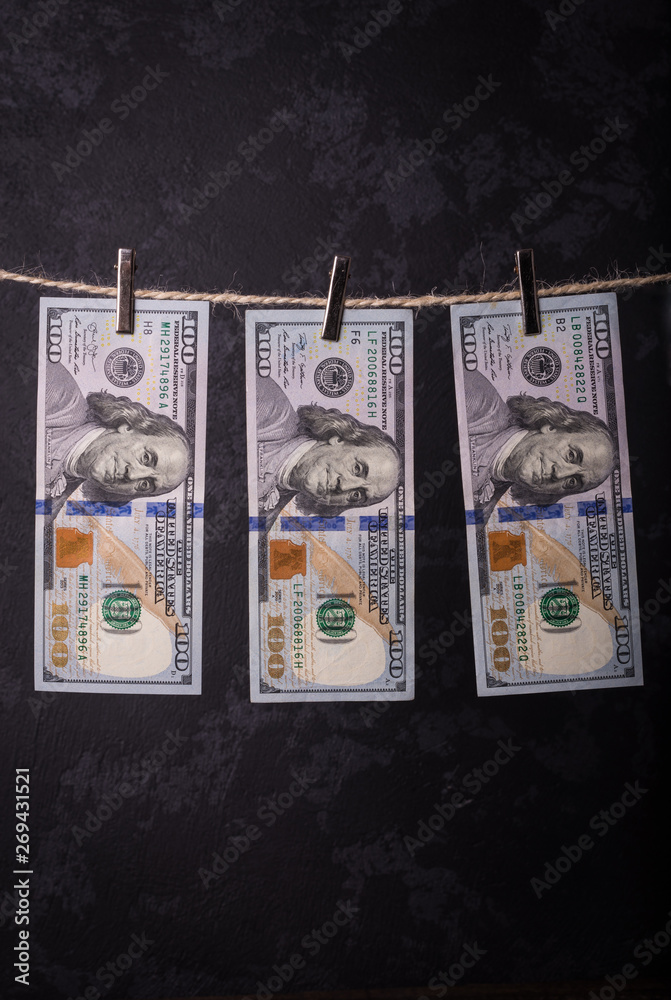 Fototapeta premium Money Laundering. Money Laundering US dollars hung out to dry. 100 dollar bills hanging on clotheslines