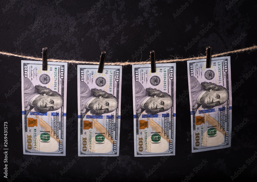 Fototapeta premium Money Laundering. Money Laundering US dollars hung out to dry. 100 dollar bills hanging on clotheslines