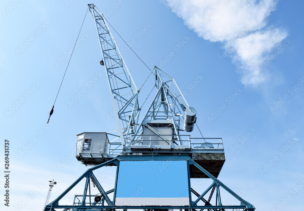 Harbour crane on which an empty advertising poster is attached for self-labelling Harbour crane on which an empty advertising poster is attached for self-labelling