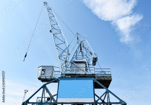 Harbour crane on which an empty advertising poster is attached for self-labelling