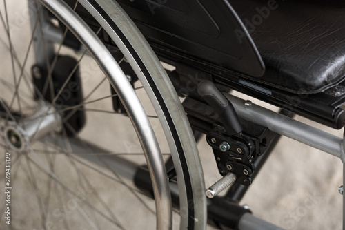 selective focus of black wheelchair with leather seat © LIGHTFIELD STUDIOS
