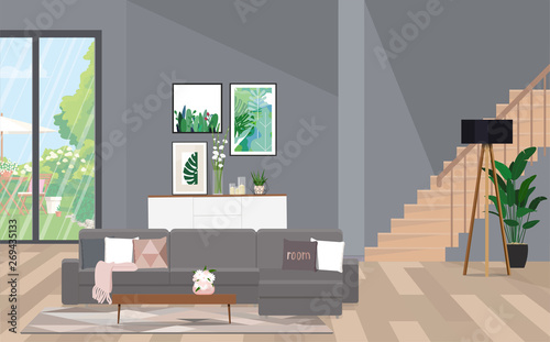 Open space with a staircase, a seating area and access to the backyard.