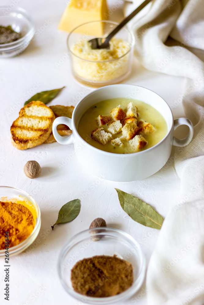 Cheese cream soup on a white background. White bread croutons. Ingredients. Cheese cream soup on a white background. White bread croutons. Ingredients.