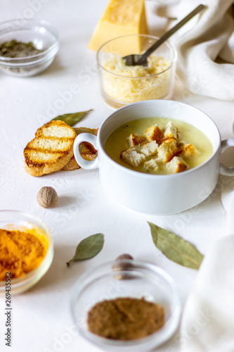 Cheese cream soup on a white background. White bread croutons. Ingredients.