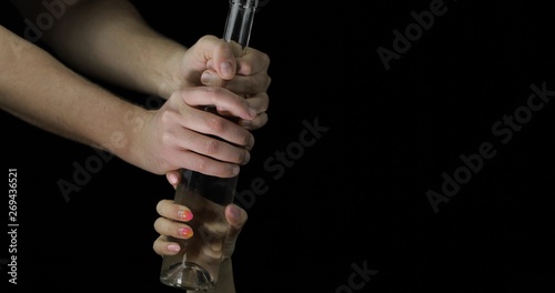 Alcoholic taking vodka from woman hand. Concept of alcoholism in family