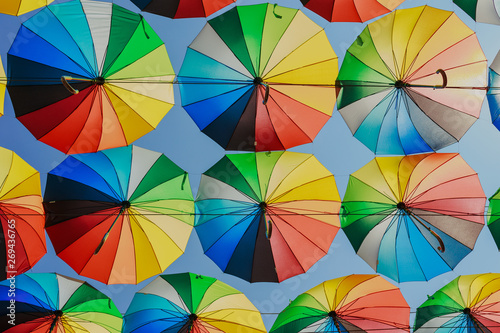 Colorful razchetsetnye umbrellas against the sky, toned.