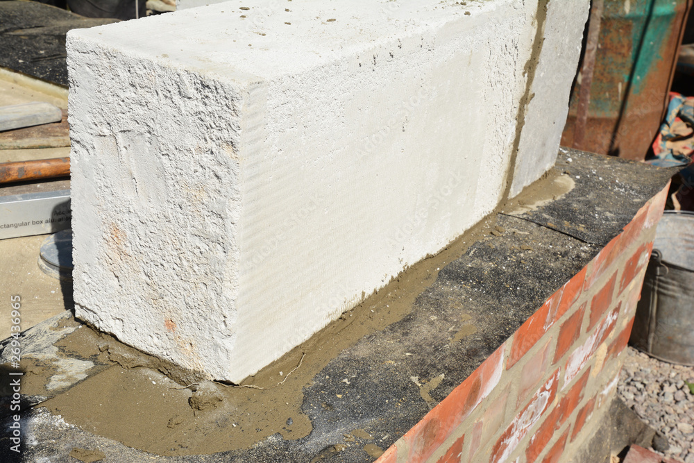 Close up on autoclaved aerated concrete block laying on foundation waterproofing membrane Close up on autoclaved aerated concrete block laying on foundation waterproofing membrane
