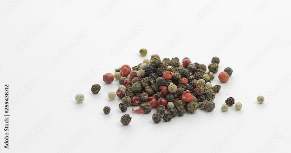 Mix of multicolored pepper. Peas with spices. Macro on white background Mix of multicolored pepper. Peas with spices. Macro on white background