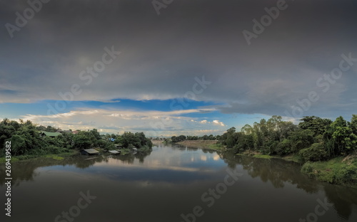 Panorama river view evening of Mae Klong river with soft rain and cloudy sky background, Ban Pong District, Ratchaburi, Thailand.