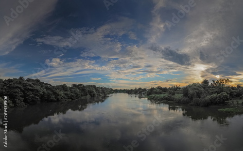 Panorama river view evening of Mae Klong river with soft rain and cloudy sky background, Ban Pong District, Ratchaburi, Thailand.